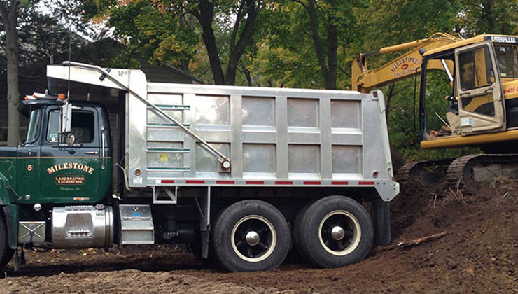 excavator loading a dump truck